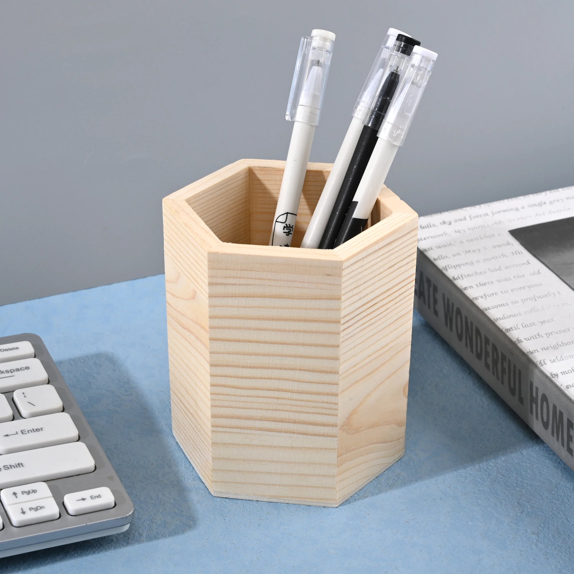 Wooden pencil holder in square, round, and hexagon shapes for office desk stationery storage and organization.