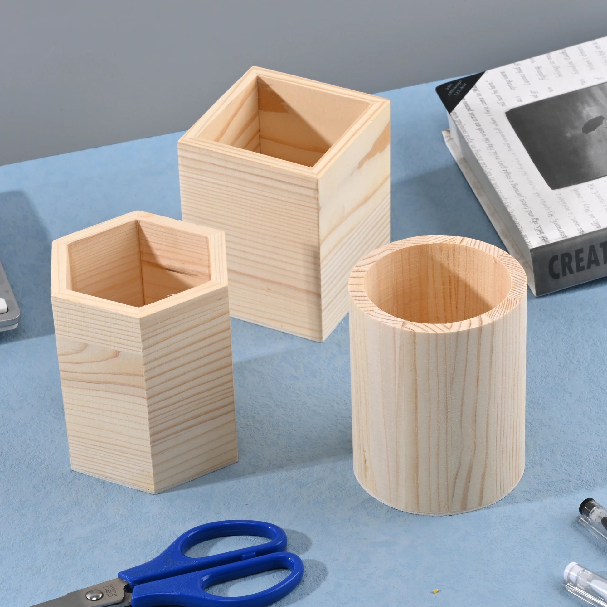 Wooden square, round, and hexagon pencil holder for office desk storage, organizing pens, pencils, and stationery supplies.