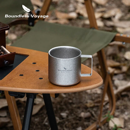 Boundless Voyage titanium double wall mini camping coffee mug, 220ml lightweight outdoor tableware, shown in natural outdoor setting