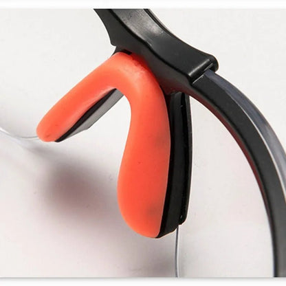 Transparent safety goggles for cycling and lab work, protective eyewear with secure fit and clear impact-resistant lenses.