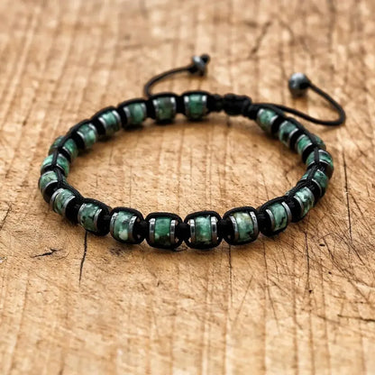 Men's and women's braided bracelet with natural hematite, dragon blood beads, and unakite stones, handcrafted health jewelry.