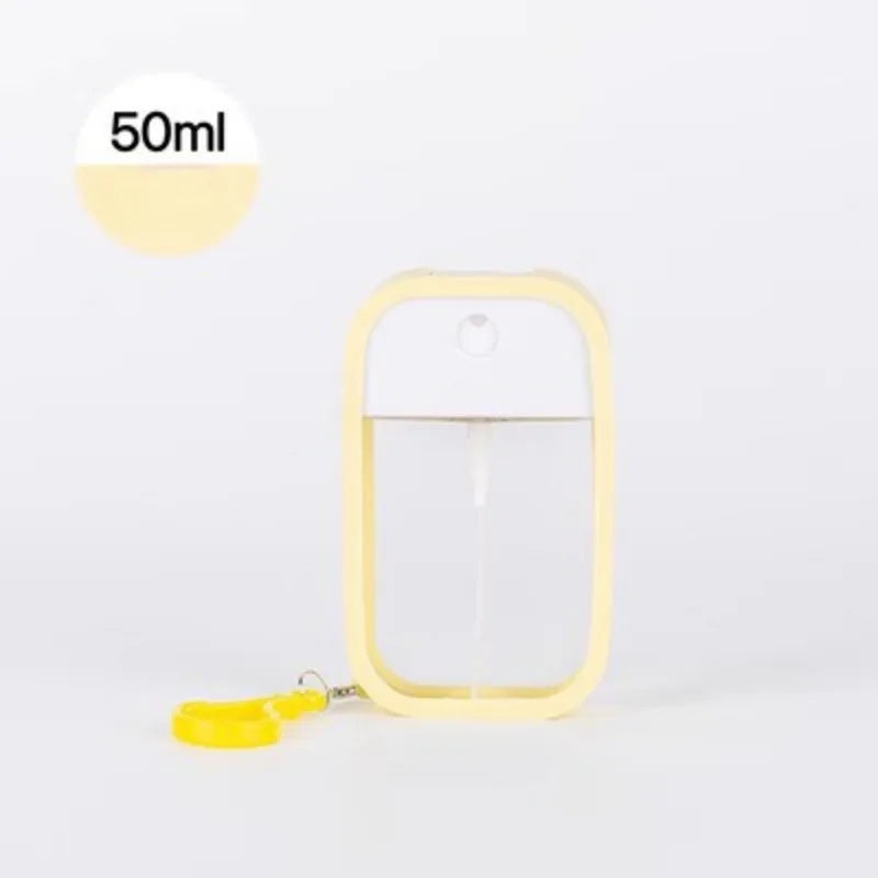 White 50ml scented vegan hand sanitizer spray bottle with keychain, compact travel disinfectant and perfume dispenser.