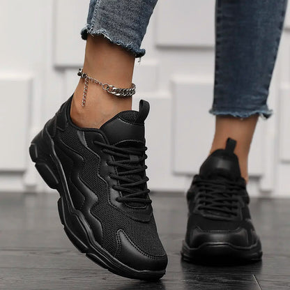 Black lightweight mesh sneakers for women and men, breathable and versatile casual shoes with a sleek design.