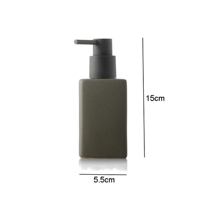 White ceramic bathroom hand sanitizer and lotion bottles, square-shaped soap liquid containers, part of bathroom accessories collection.