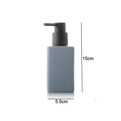 White ceramic bathroom hand sanitizer and lotion bottles with square design and press-top soap liquid container for bathroom accessories.