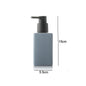 White ceramic bathroom hand sanitizer and lotion bottles with square design and press-top soap liquid container for bathroom accessories.