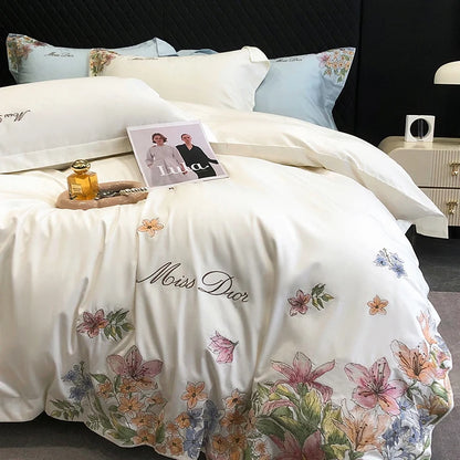 White Egyptian cotton bedding set with luxury embroidered flowers, includes duvet cover, fitted sheet, mattress cover, and pillowcases.