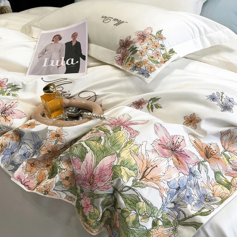 Luxury white Egyptian cotton bedding set with embroidered flowers, including quilt, duvet cover, fitted sheet, mattress cover, and pillowcases.