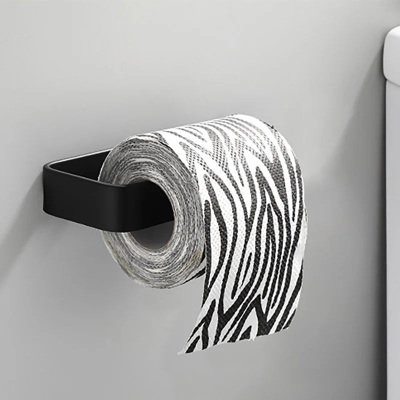 White kitchen paper towel holder and adhesive tissue hanger with toilet roll dispenser and cabinet storage for bathroom accessories.