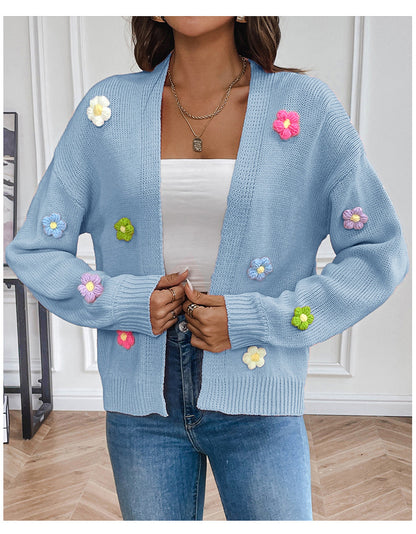 White knitted women's cardigan with floral design, featuring a cozy, stylish sweater coat from BackupMyFilesNow.com.