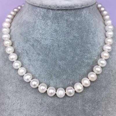 Natural freshwater pearl necklace featuring white pearls on a delicate strand, crafted for elegant jewelry wear.