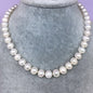Natural freshwater pearl necklace featuring white pearls on a delicate strand, crafted for elegant jewelry wear.
