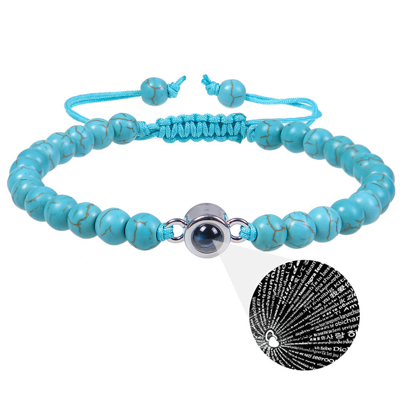 White turquoise custom photo projection bracelet by BackupMyFilesNow.com featuring engravings in 100 languages.