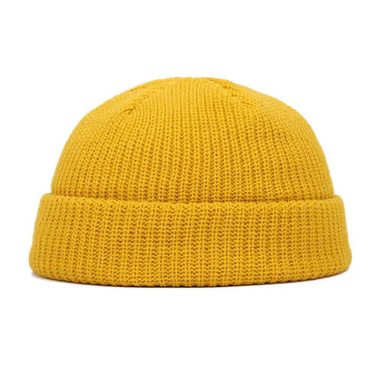 Yellow knitted beanie cap for men and women, warm and stylish solid wool skullies for autumn winter fashion.