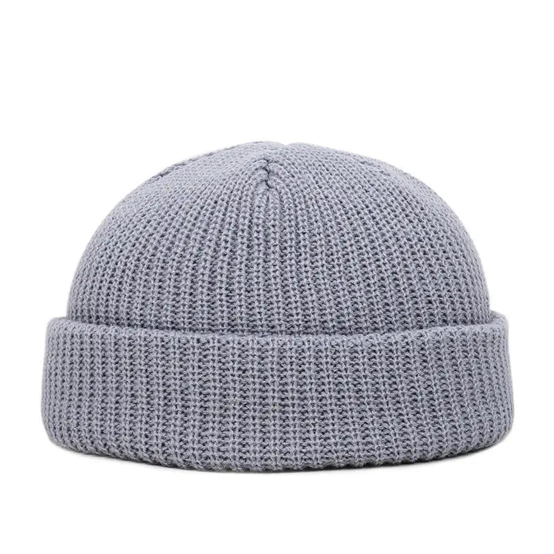 Yellow knitted beanie cap for men and women, warm and trendy wool skullie style for autumn and winter.