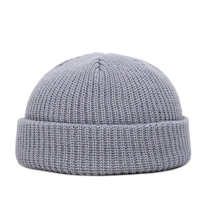 Yellow knitted beanie cap for men and women, warm and trendy wool skullie style for autumn and winter.