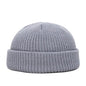Yellow knitted beanie cap for men and women, warm and trendy wool skullie style for autumn and winter.