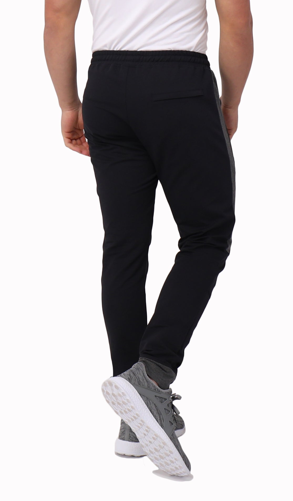 Close-up of black SCR Sportswear Infinite Flex Tall Fit men's joggers sweatpants showing fabric texture and stitching details.