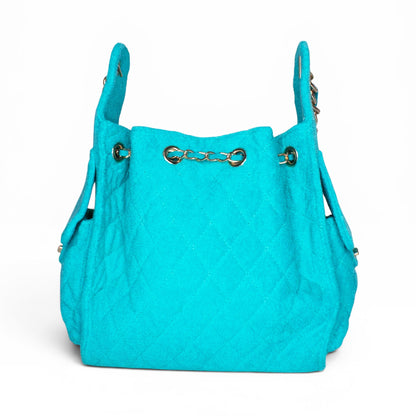 Small turquoise Bayshore Bucket bag by BEACH HAUS with a woven texture and round handles, perfect for casual outings.