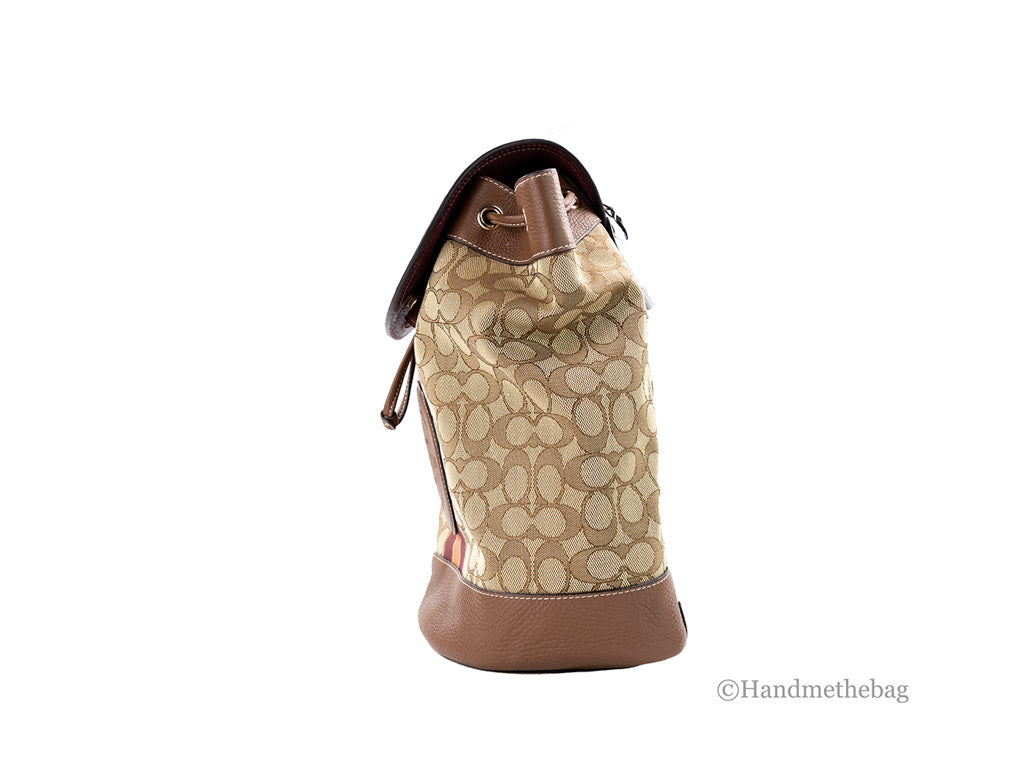 Coach Dempsey khaki saddle signature jacquard canvas patch backpack with adjustable straps and front patch pocket.