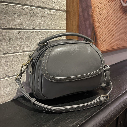 Top-grain leather women's vintage single-shoulder crossbody handbag with a small round design