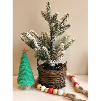Mini Christmas tree decorations arranged in a festive Christmas layout