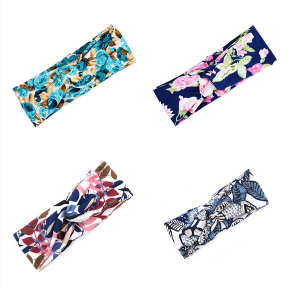 Floral cross hair band with delicate flower detailing, displayed against a clean background
