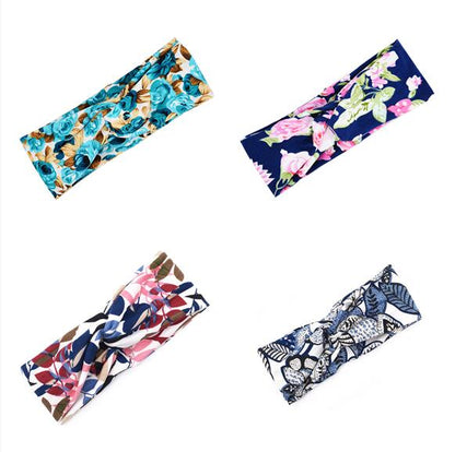 Floral cross hair band with delicate flower detailing, displayed against a clean background