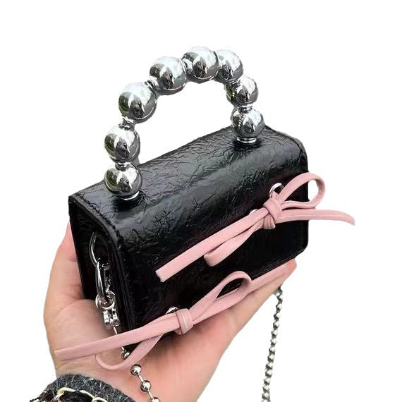 Textured cute bow mini chain handbag with compact silhouette and decorative bow detail