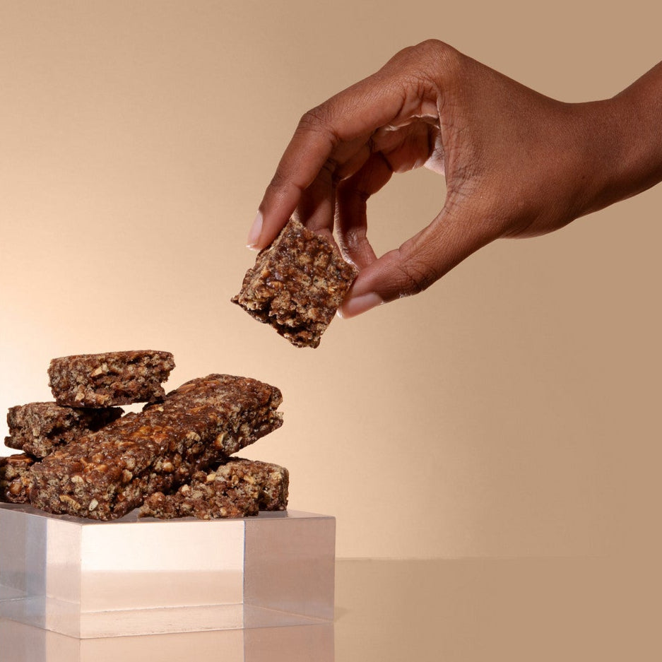 Biocare 15G Protein Graham Cracker Fudge Bar showing the snack with a chocolate and graham cracker coating on a plate.