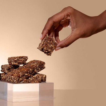 Biocare 15G Protein Graham Cracker Fudge Bar showing the snack with a chocolate and graham cracker coating on a plate.