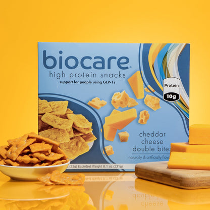 Biocare High Protein Cheddar Cheese Double Bites in a clear bowl, showcasing golden cheese bites ready to eat.