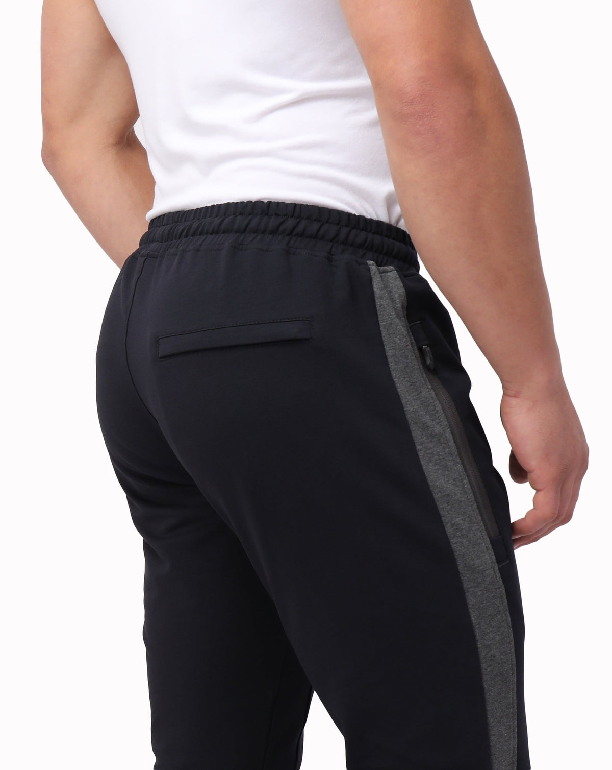 Close-up of black SCR Sportswear Infinite Flex Tall Fit men's joggers sweatpants showing fabric detail and tailored fit.