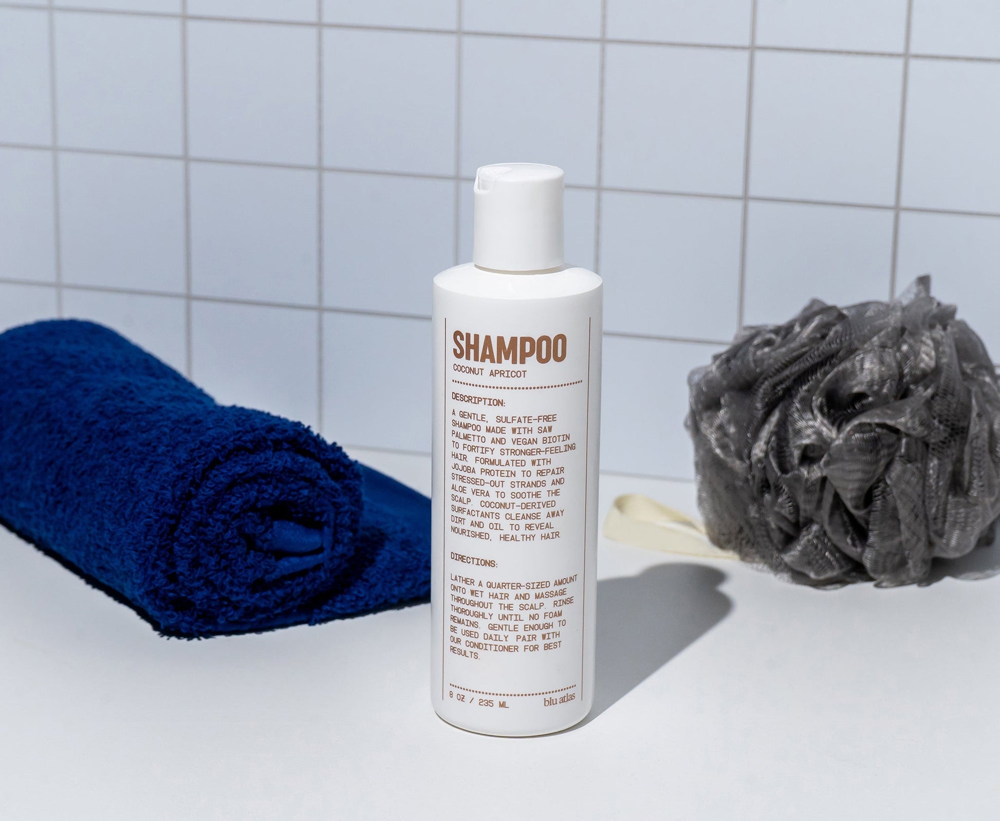 Blu Atlas Natural Shampoo for hair, 8oz bottle, showing the sleek packaging and label of the hair care product.
