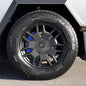 Set of four Tesery Official Cybertruck brake caliper covers showing black and silver design on a shiny automotive wheel.