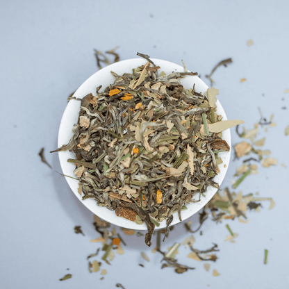Organic Buddha's Potion blend by Nepal Tea, featuring a vibrant herbal infusion with fresh organic herbs and flowers in a glass jar.