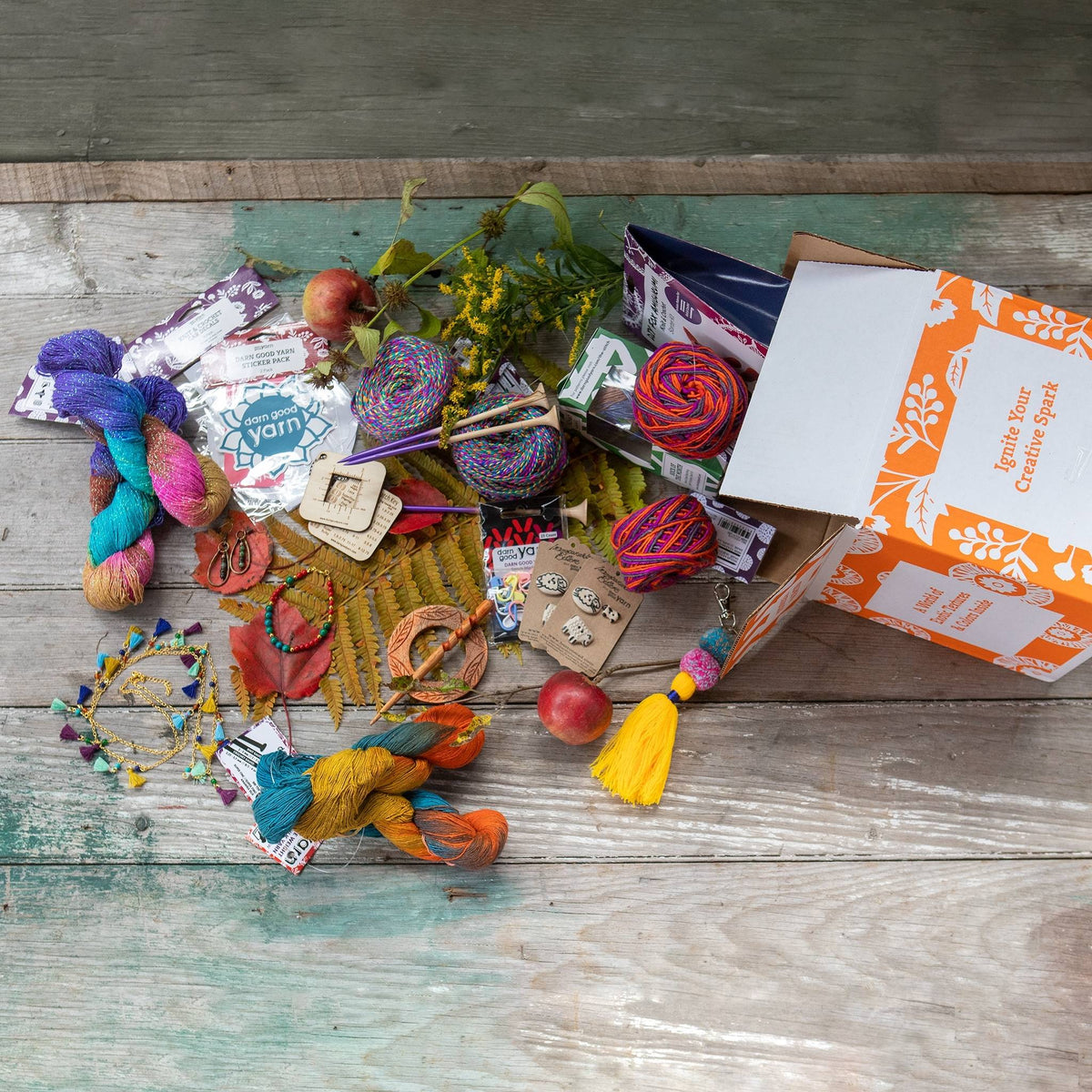 Recycled sari silk yarn bundle by Darn Good Yarn, vibrant golden and warm hues, perfect for colorful knitting or crafting projects.