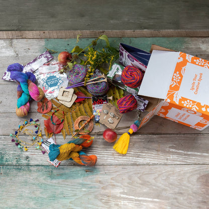 Recycled sari silk yarn bundle by Darn Good Yarn, vibrant golden and warm hues, perfect for colorful knitting or crafting projects.