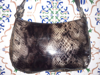 Handmade women's bag with handles, stylish and spacious, featuring natural leather textures and detailed craftsmanship.