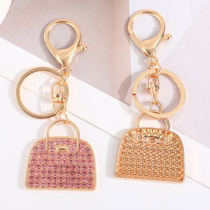 Creative minimalist diamond-studded handbag charm keychain in a compact decorative design