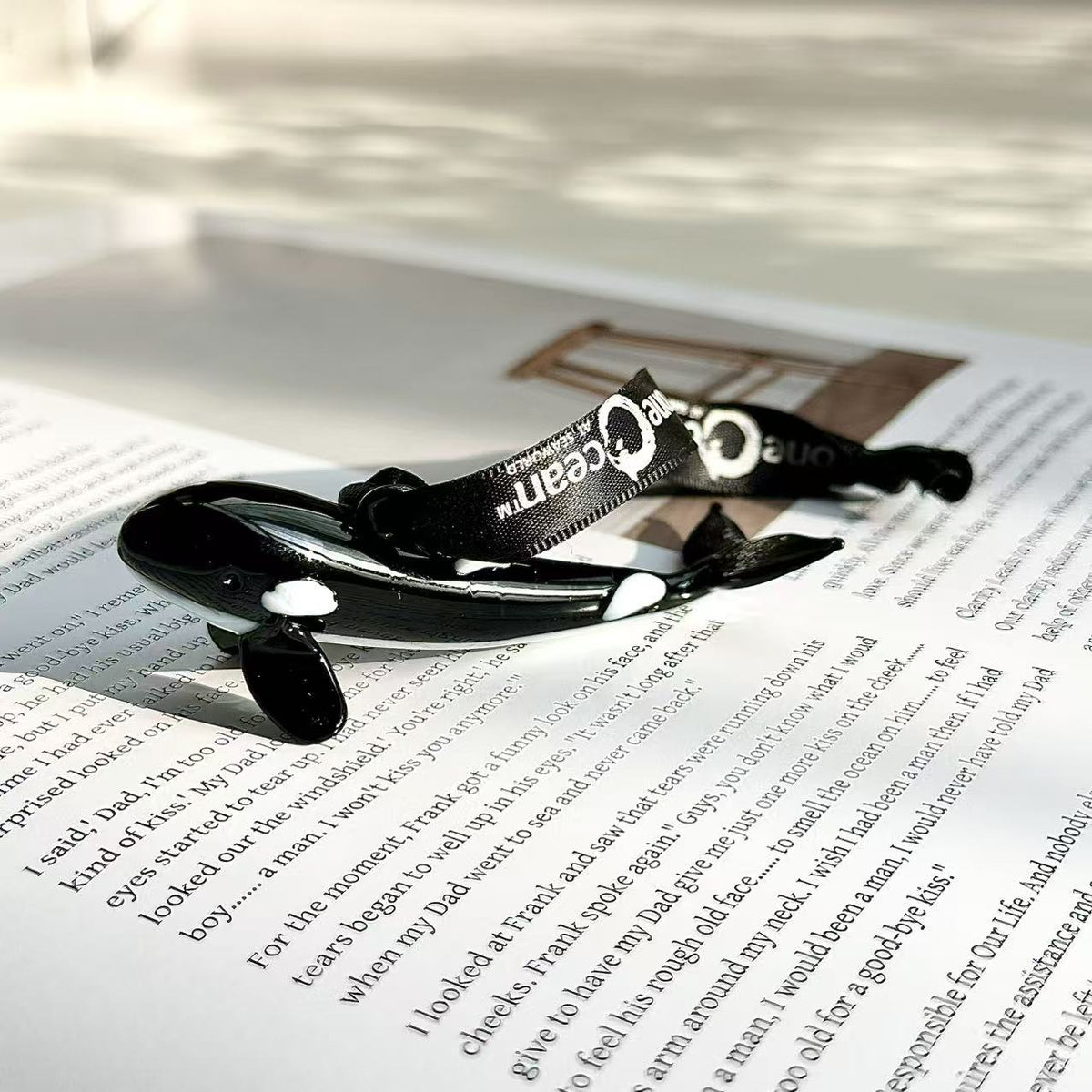 Small decorative orca-shaped glass pendant ornament in a glossy black-and-white design