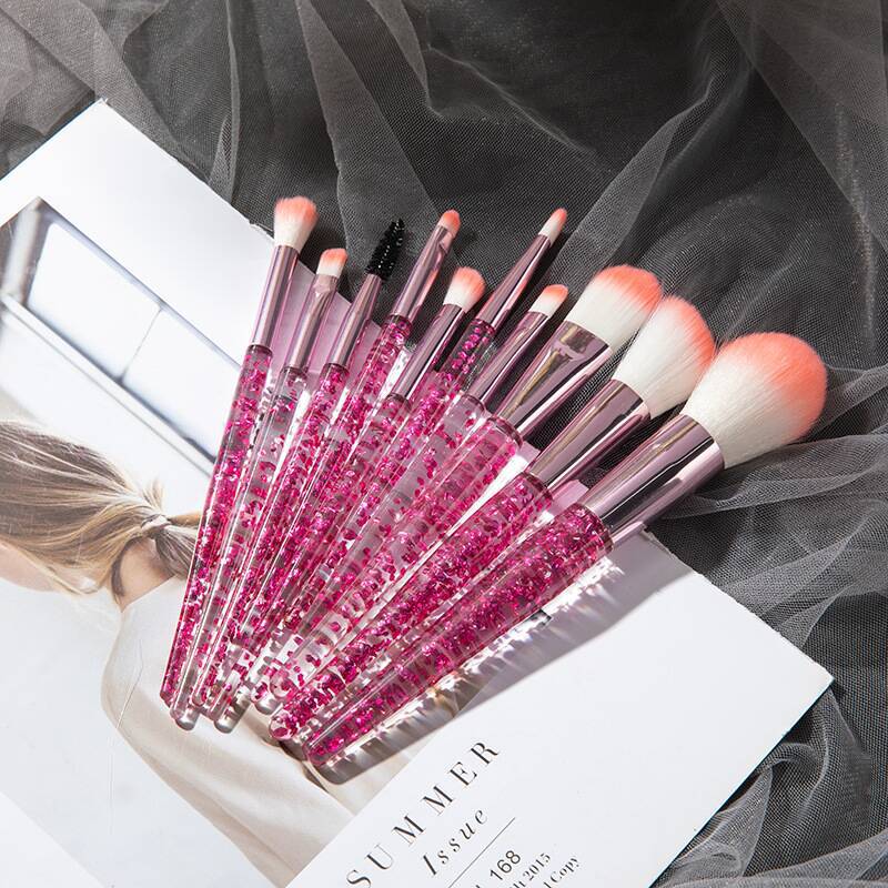 Set of 10 essential makeup brushes from BACKUPMYFILESNOW® including face, eye, and blush brushes arranged on a white background.