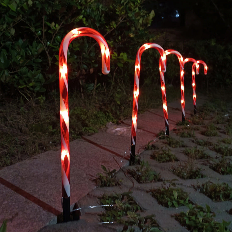 Solar-powered candy cane string lights for Christmas home decor, glowing along outdoor pathways