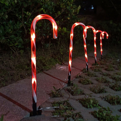 Solar-powered candy cane string lights for Christmas home decor, glowing along outdoor pathways