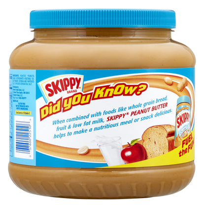 Creamy SKIPPY peanut butter in an 80 oz jar showing the smooth, spreadable peanut butter with a peanut and spoon on the side.