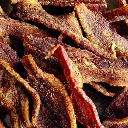 Cedar Valley Cuts Brown Sugar Cinnamon Bacon Jerky in snack size, showcasing glazed bacon slices with cinnamon and brown sugar.