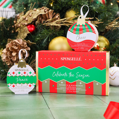 Spongellé Celebrate the Season holiday ornament gift set with body wash infused buffers displayed in a festive setting.