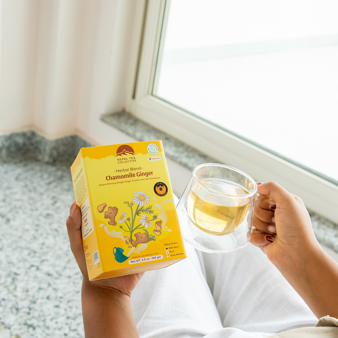 Organic chamomile and ginger tea blend by Nepal Tea, featuring fresh chamomile flowers and ginger roots in the image.