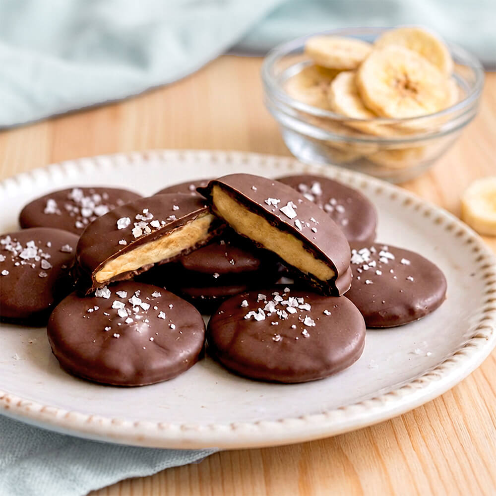 Freeze-dried banana slices with chocolate coating from VFD.US, showcasing a crunchy, single-ingredient fruit snack.