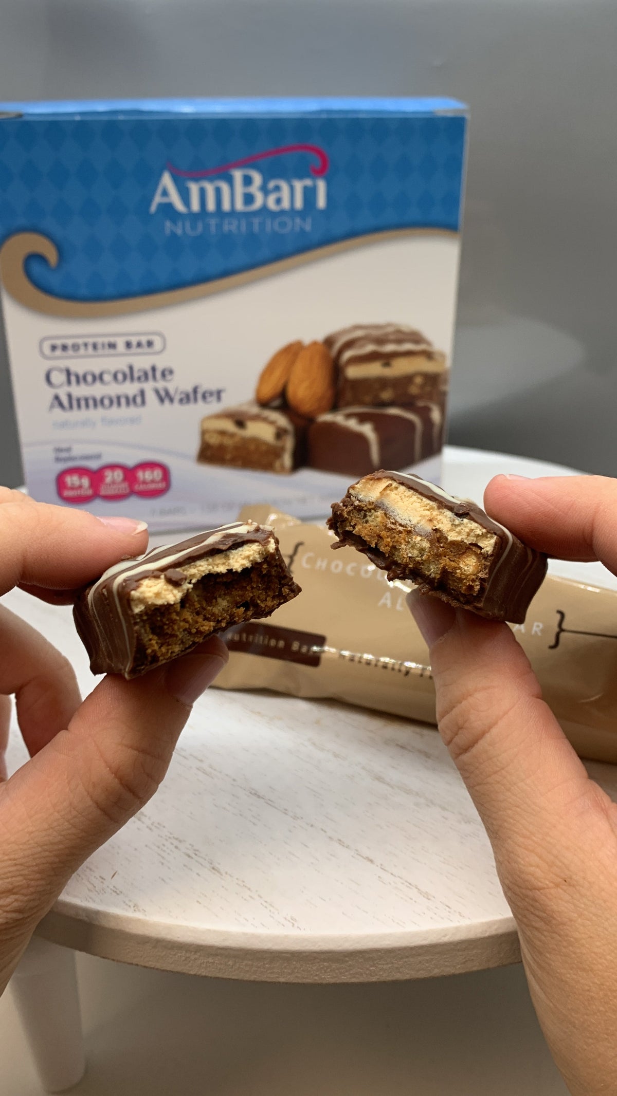 Close-up of AmBari Nutrition chocolate almond wafer bar, showing layered chocolate and almond filling with a crispy wafer exterior.
